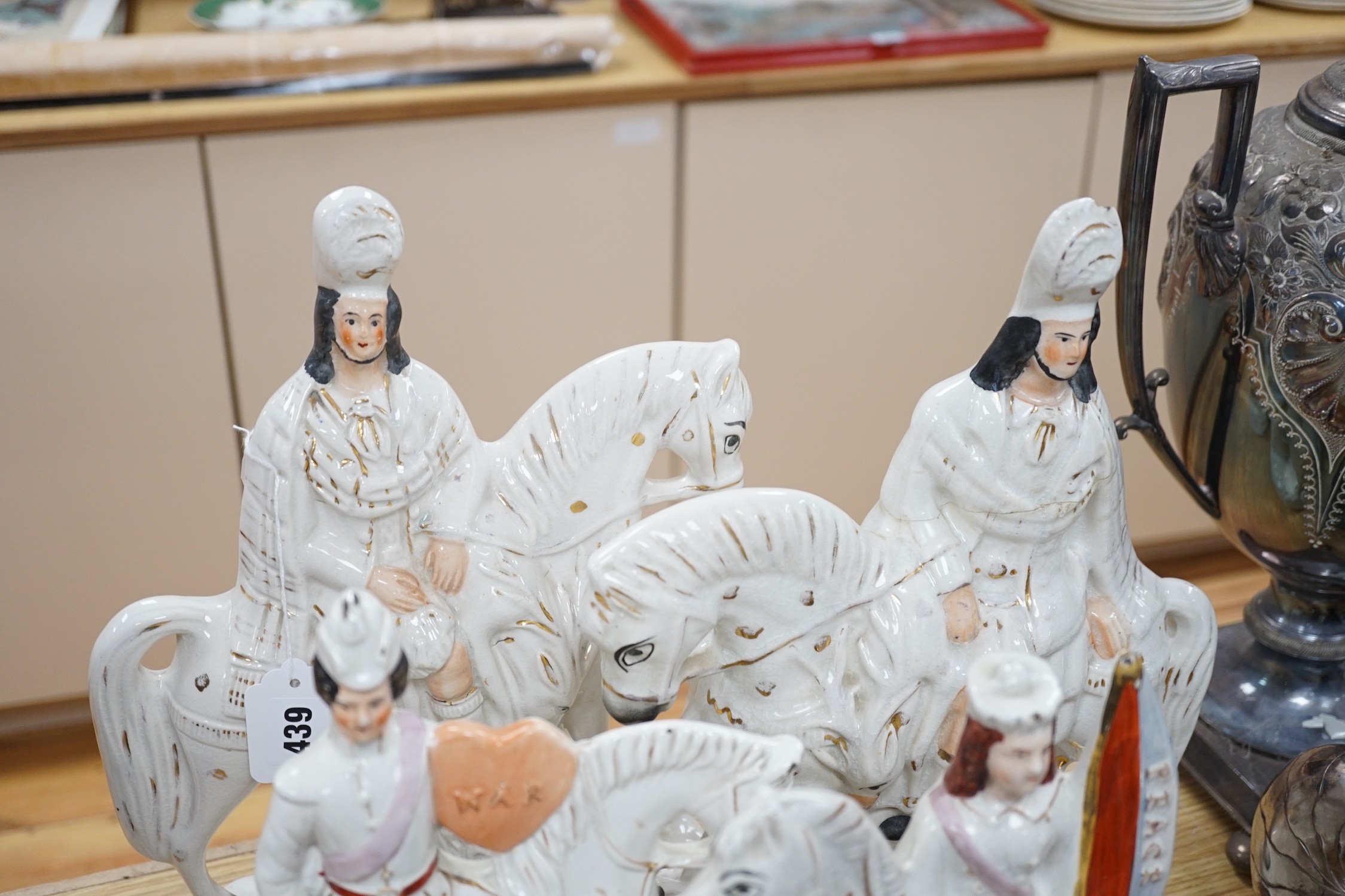 Two pairs of Staffordshire flat backs of figures on horseback, two others, a mother and child and flower seller